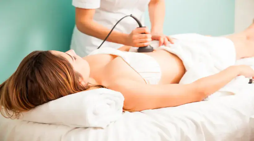 Body RF microneedling treatment on the abdomen with a handheld device in a clinical spa setting - Dr. Elham Keikha Dubai