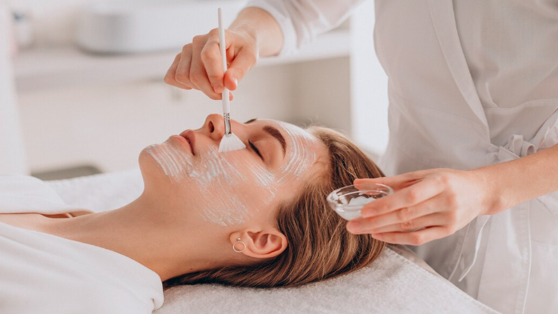 Practitioner applying medical-grade skincare product during a professional facial treatment