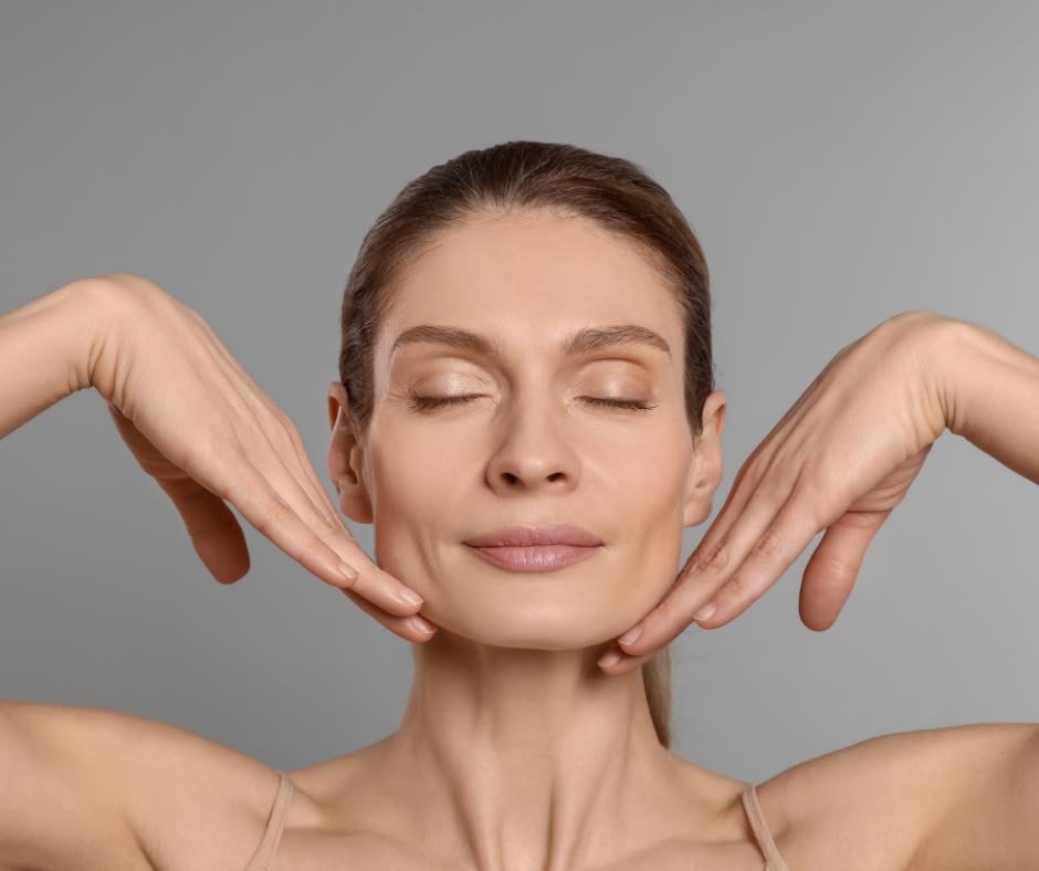 Close-up of a woman serenely touching her jawline, representing professional face and neck aesthetic treatments - Dr. Elham Keikha Dubai