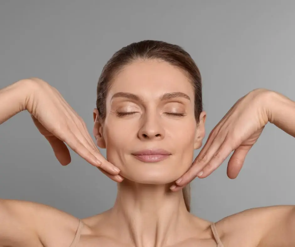 Close-up of a woman serenely touching her jawline, representing professional face and neck aesthetic treatments - Dr. Elham Keikha Dubai