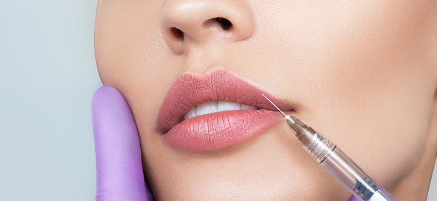 Close-up of a professional lip filler procedure showing a precise injection into the upper lip by a specialist in purple gloves, representing lip enhancement services in Dubai