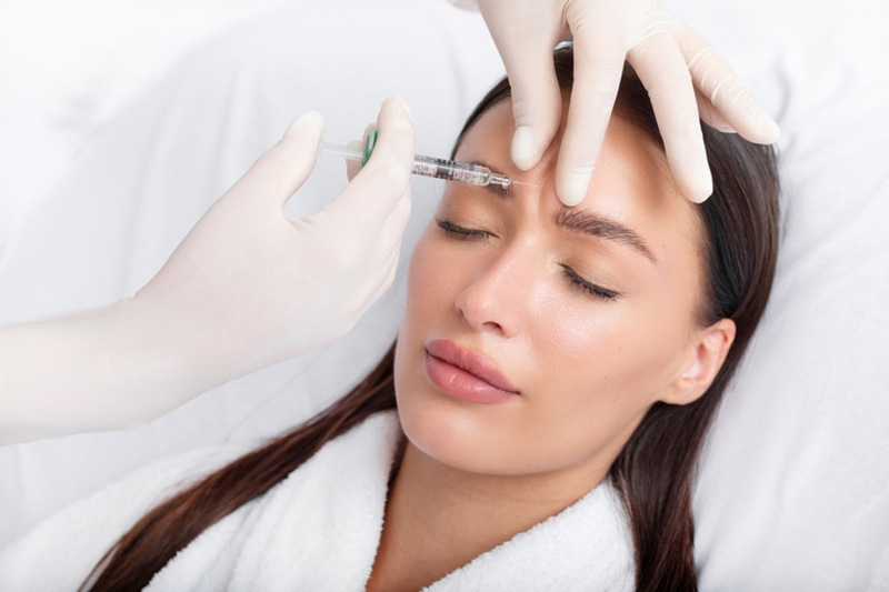 Close-up of a precise glabella Botox injection by a specialist in a sterile Dubai clinic, highlighting Dr Elham's careful technique