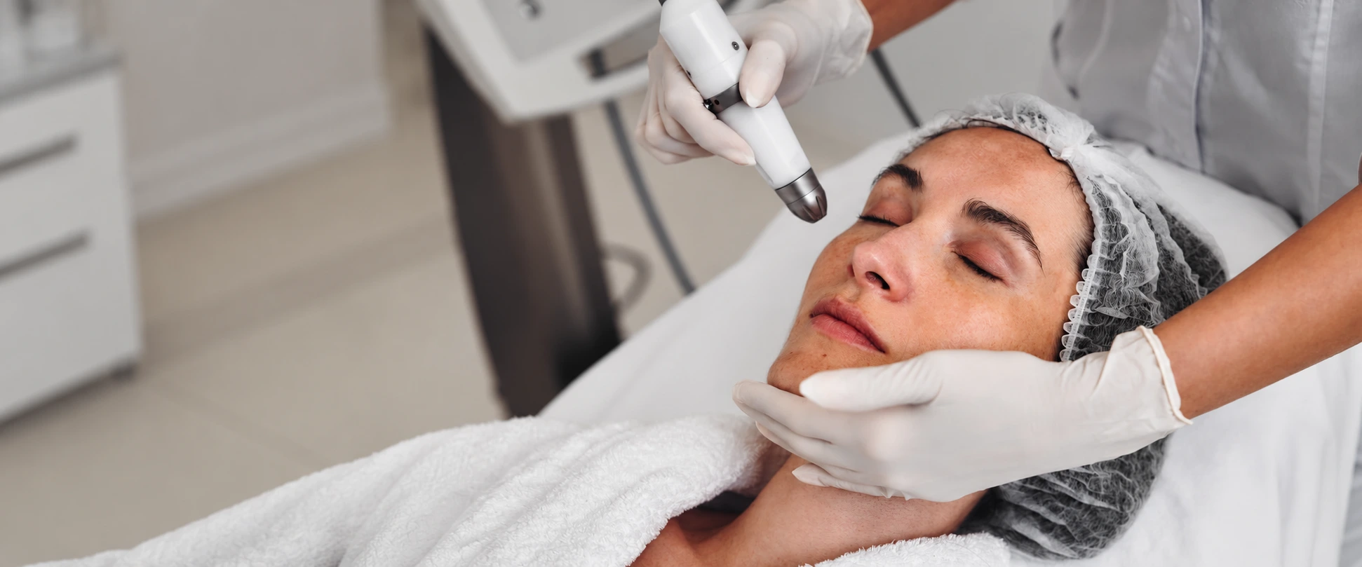 Relaxed woman receiving professional RF microneedling facial treatment for collagen remodeling and skin tightening at Dr. Elham Keikha clinic in Dubai